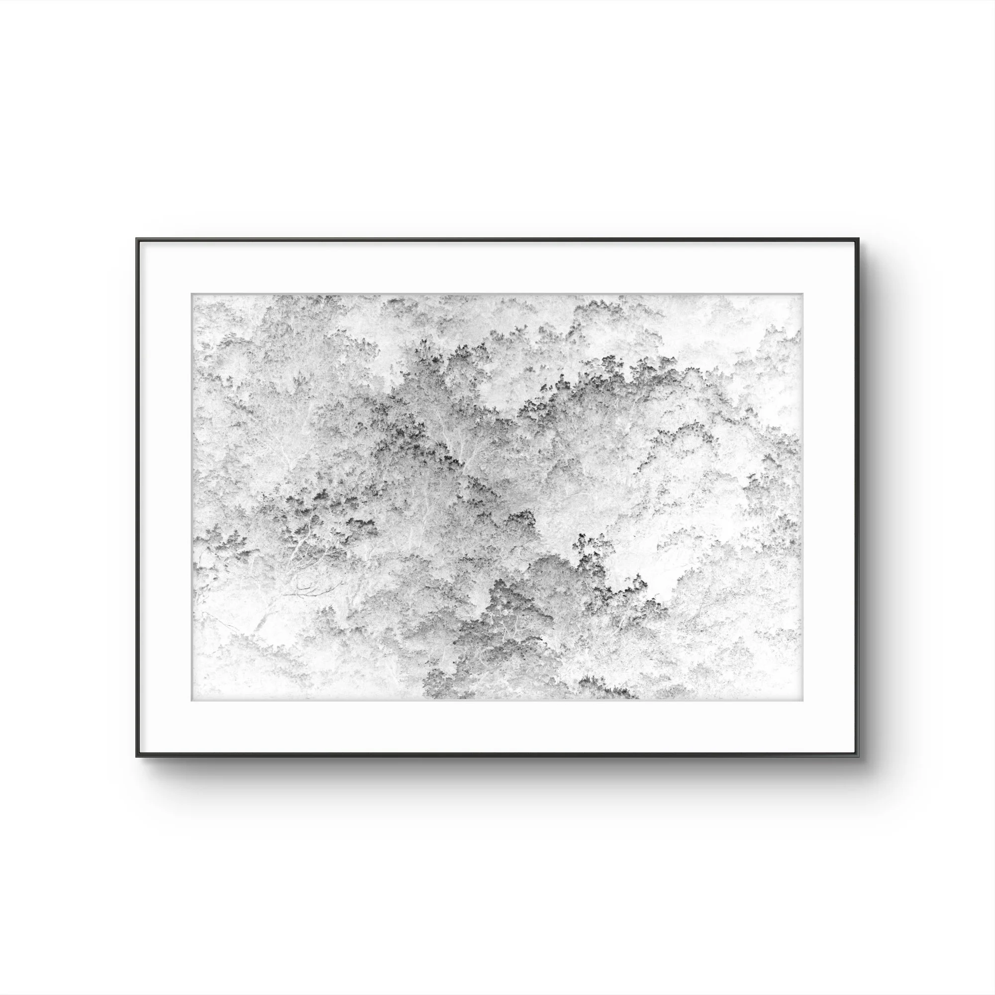 Une œuvre d'art abstraite en noir et blanc encadrée, présentant des textures nuageuses et de la pierre
