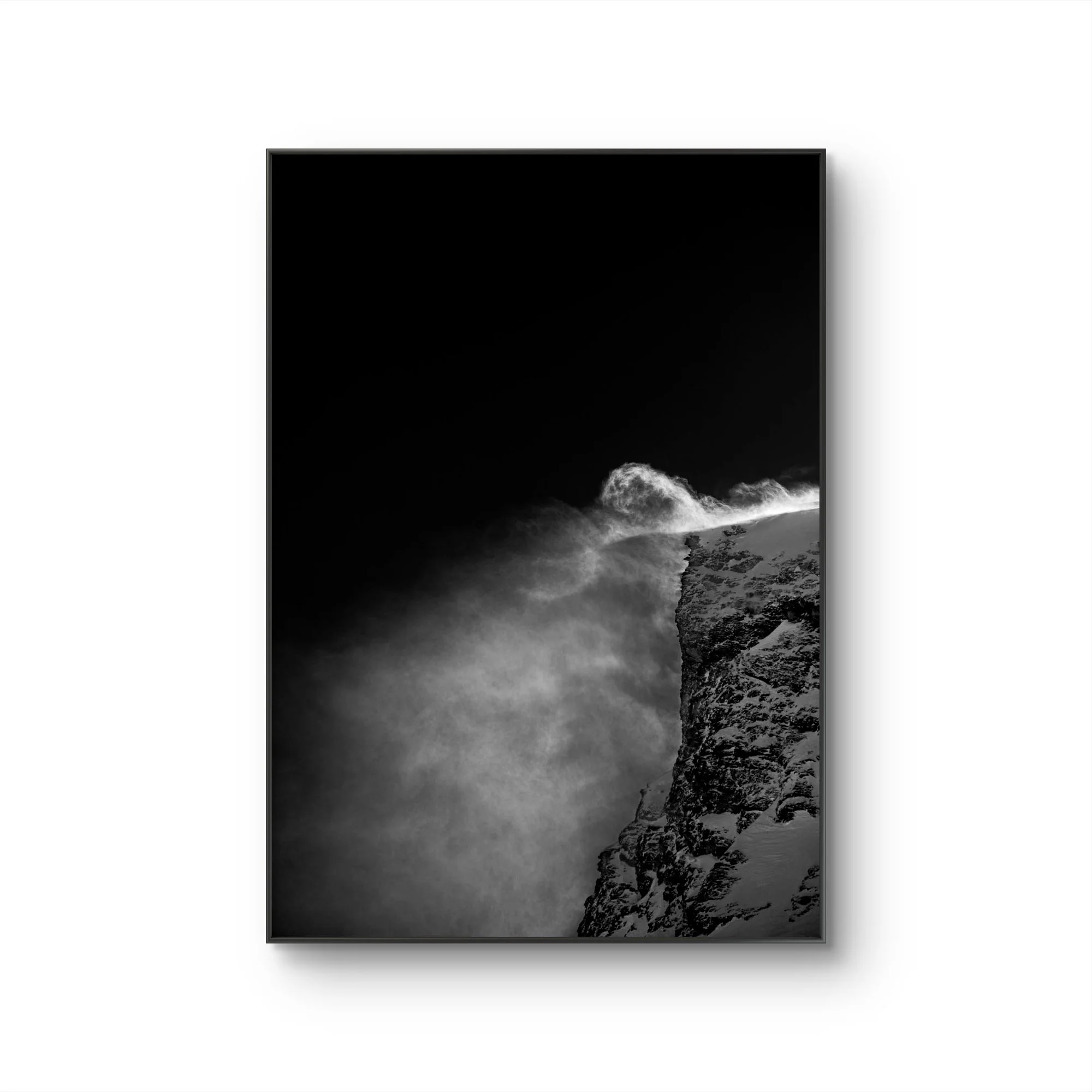 Une photographie en noir et blanc d'une scène de montagne avec des nuages et un ciel sombre, vue à travers une fenêtre.