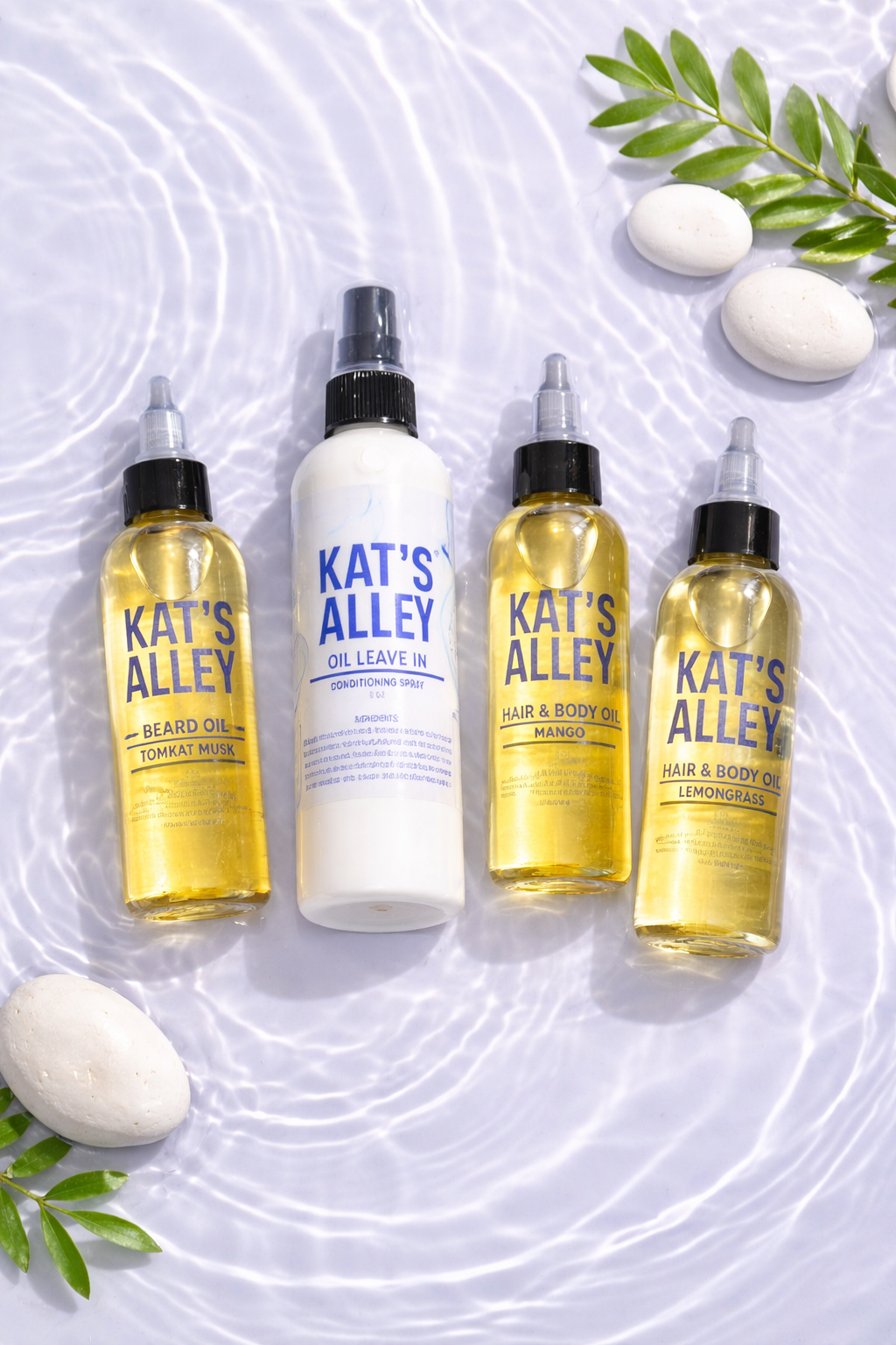 Four bottles of KAT'S ALLEY oil products arranged on water with white stones and green leaves around them.