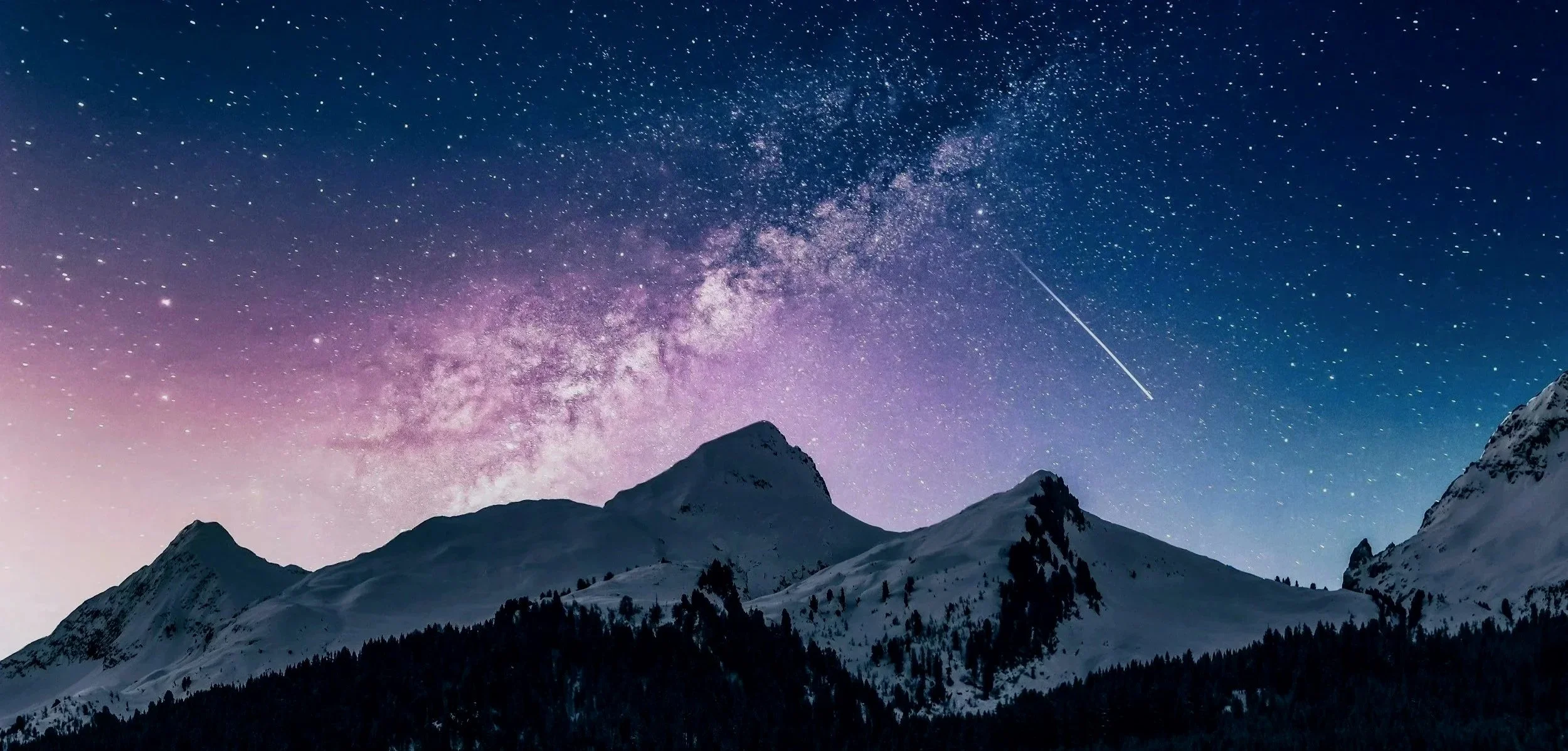 Snow-covered mountain range under a night sky with the Milky Way and a shooting star visible.