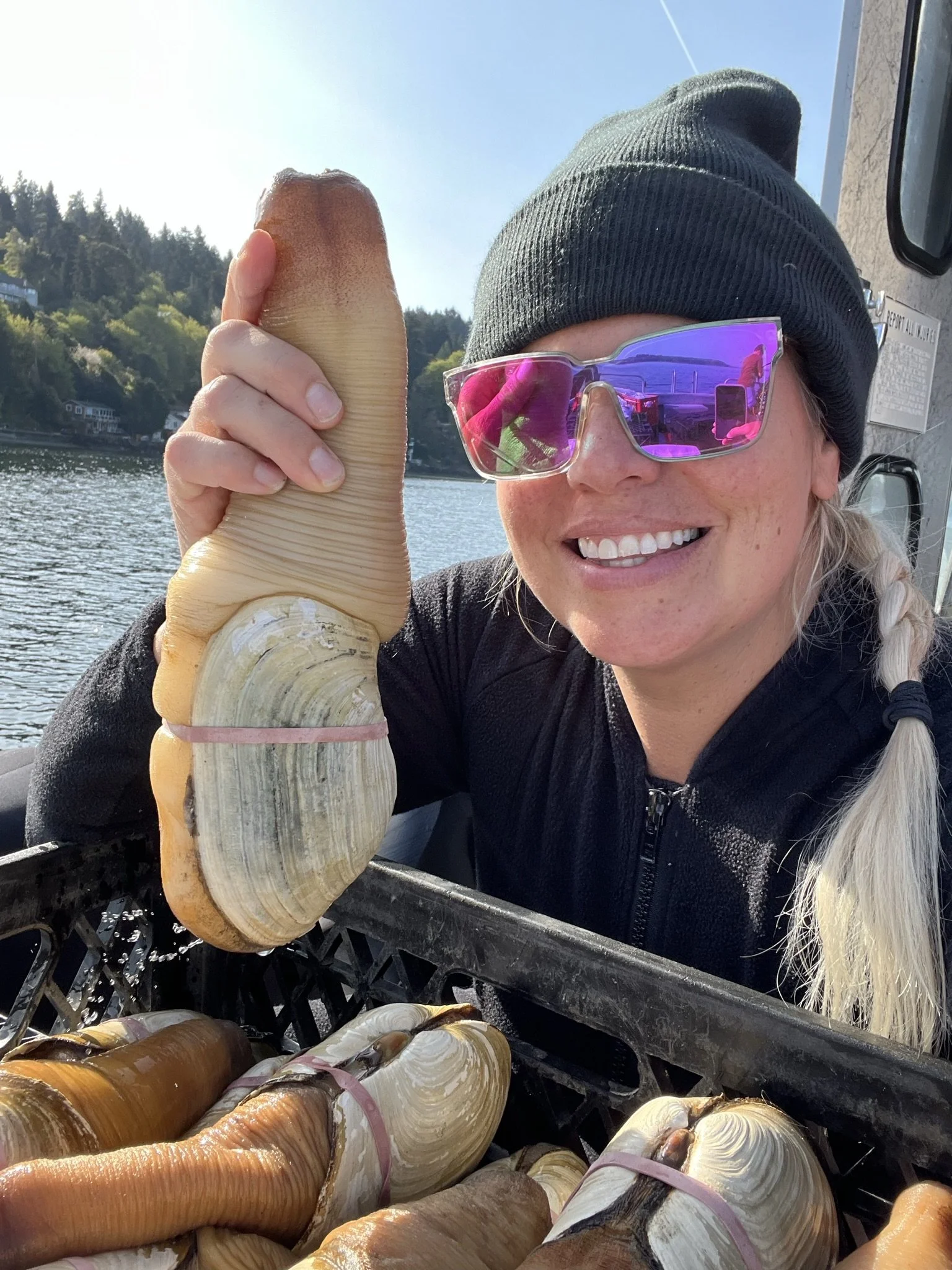 Bettina Smiling holding a Geoduck