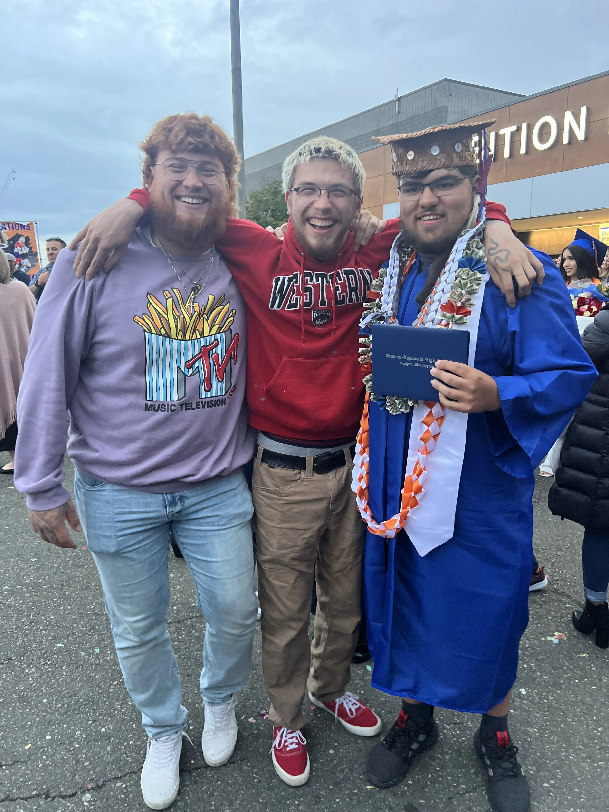 Bettina's son's standing together smiling