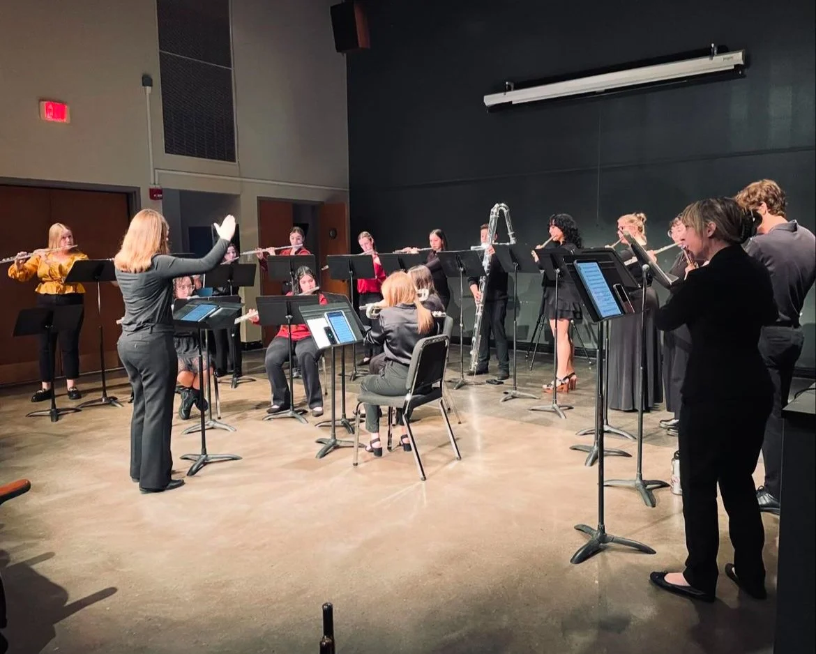 A concert performance of a flute ensemble, led by conductor Lindsey Kovach.