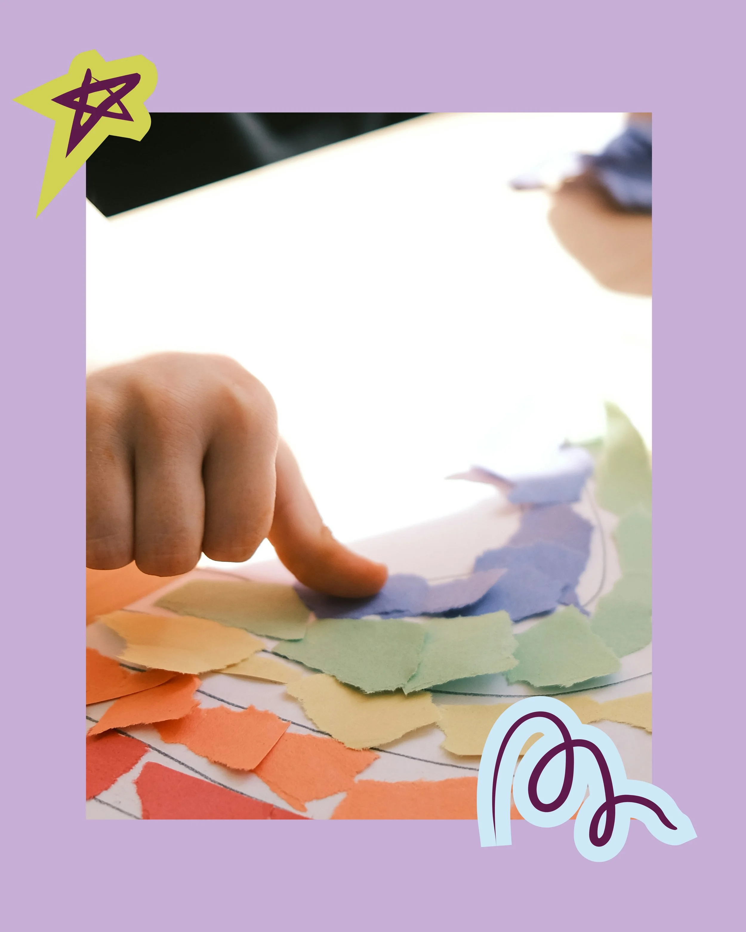 A close-up of a person's hand with a finger pointing at torn pieces of paper arranged in rainbow order on a surface, with a purple star-shaped sticker and some doodles on the border.