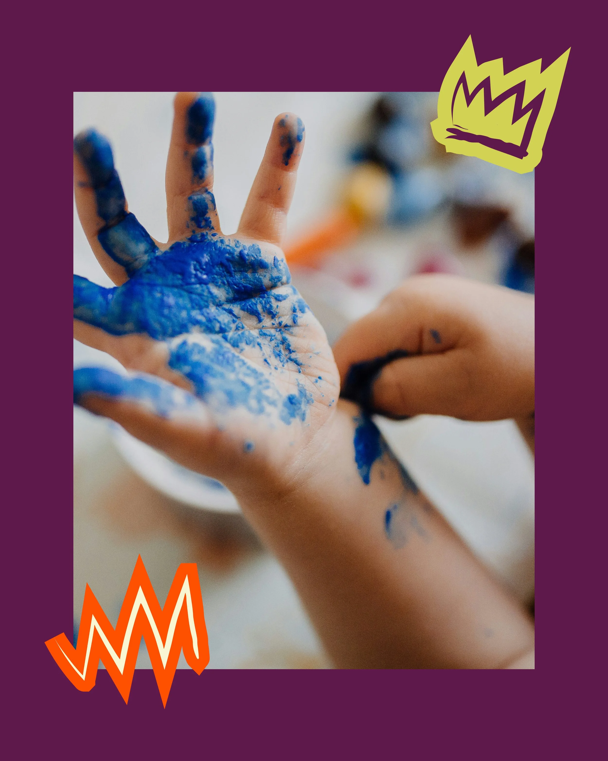 Close-up of a hand covered in blue paint, with the index finger raised and other fingers curled. There is a blurred background with colorful objects. The image has a purple border with orange zigzag lines at the bottom and a yellow-green stylized flame graphic in the top right corner.