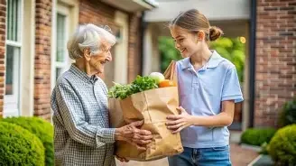 A young girl giving a paper bag of groceries to an elderly woman outside a house.