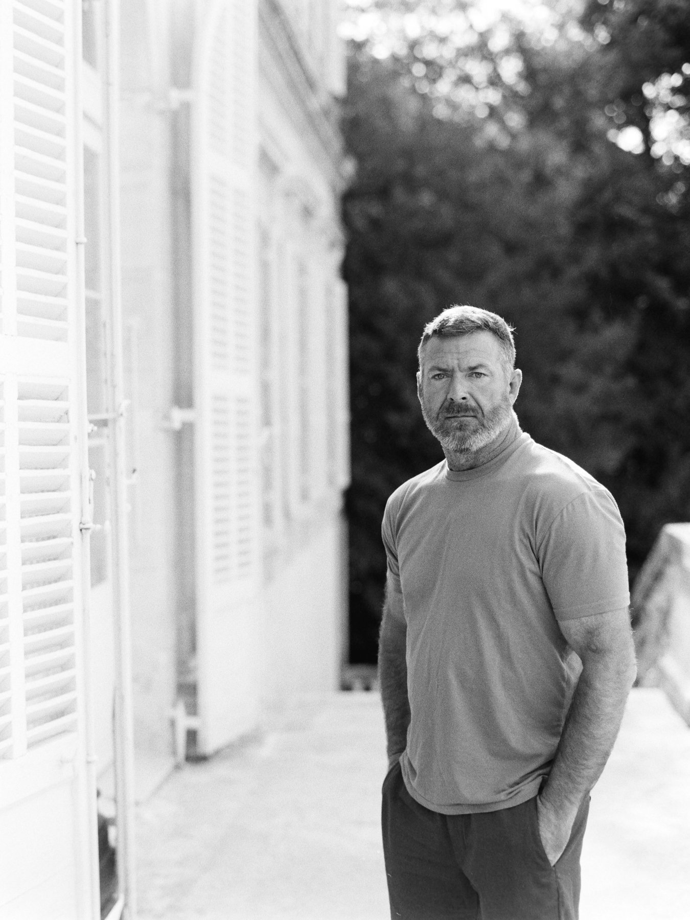 Black and White portrait of Michael standing outside Chateau Martinay in the South of France