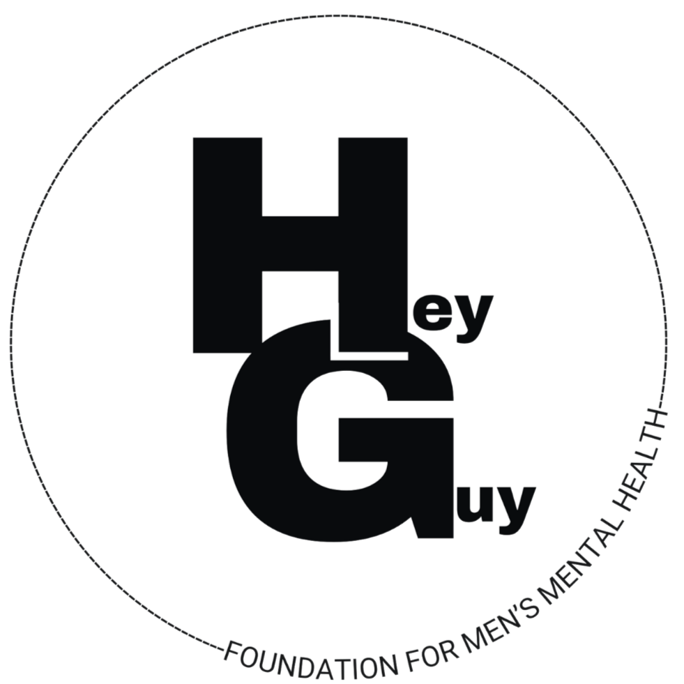 Logo for the Hey Guy Foundation, featuring large black text 'Hey Guy' inside a circle, with the tagline 'Foundation for Men's Mental Health' around the bottom edge of the circle.