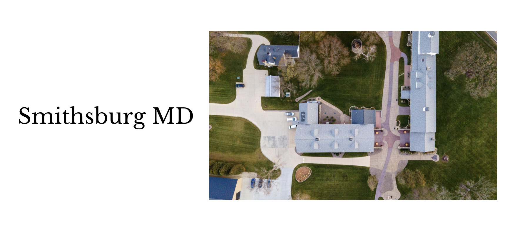 An aerial view of a large house with a drive and surrounding lawn, with neighboring houses and trees, in Smithsburg, Maryland.