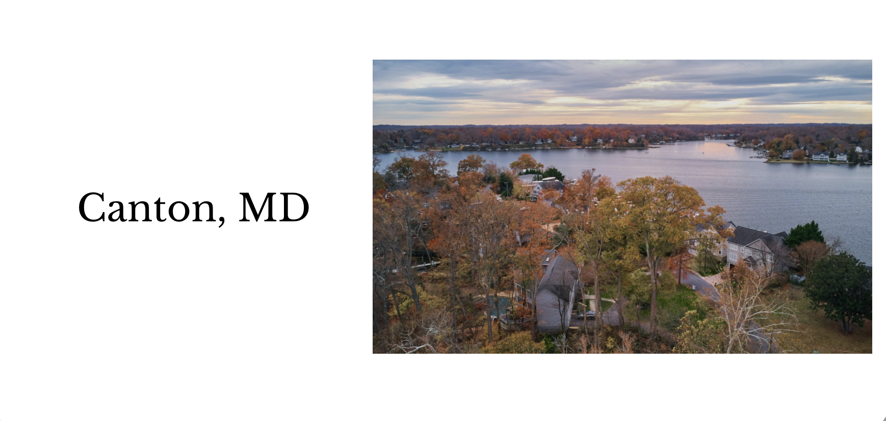 An aerial view of a residential neighborhood near a large body of water in Canton, Maryland, with autumn trees and houses during the day.