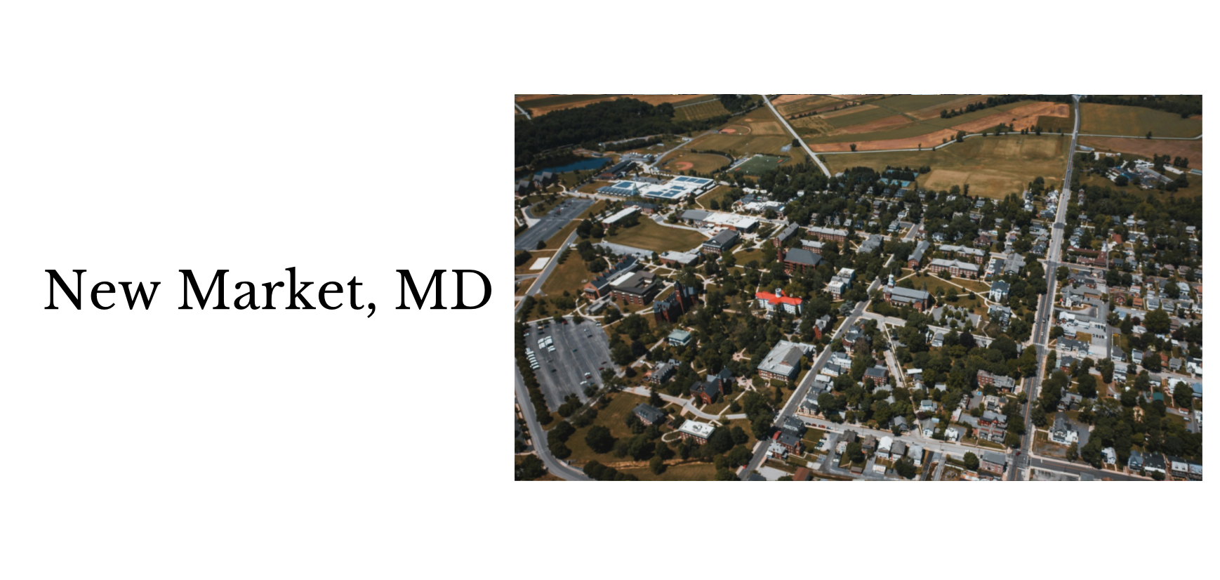 Aerial view of New Market, Maryland town with streets, buildings, trees, and surrounding countryside.