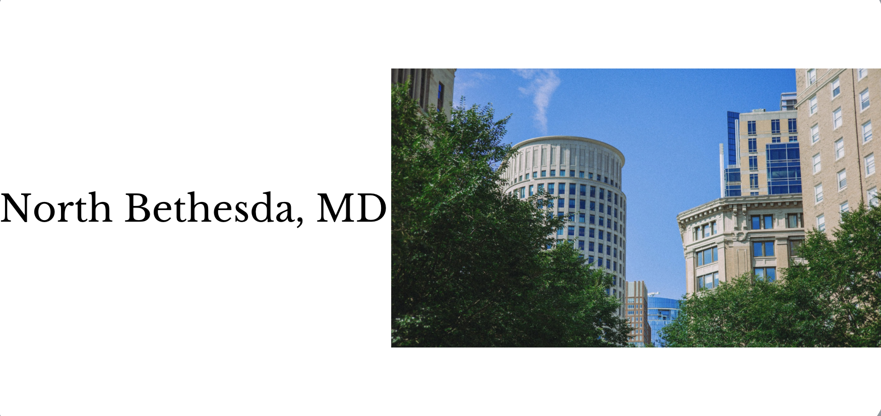 Downtown North Bethesda, Maryland with modern high-rise buildings and lush green trees under a bright blue sky.