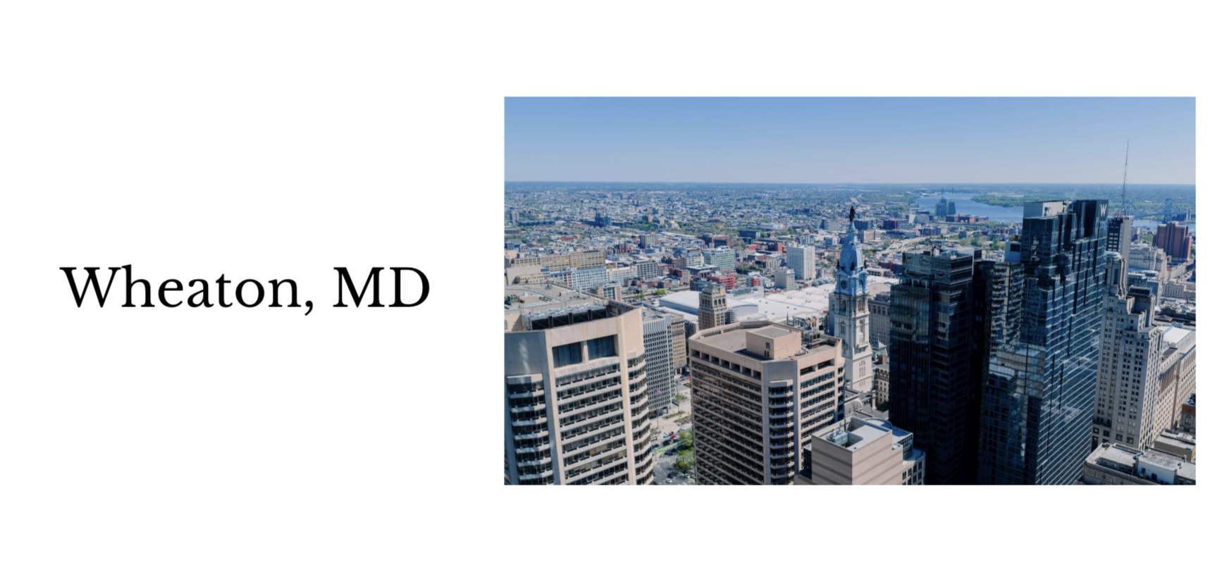 Aerial view of Wheaton, MD cityscape showing high-rise buildings, streets, and a clear blue sky.