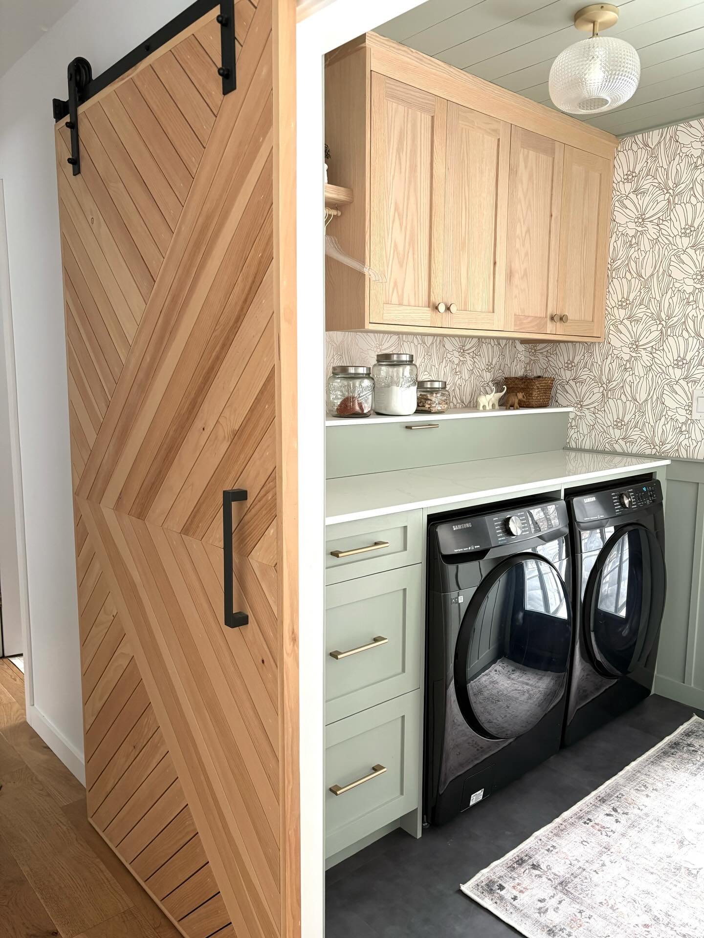 Design isn't about a fixed aesthetic. It's about responding thoughtfully to context, scale, and use.

This laundry room features a custom-crafted barn door that creates a defined space. This allows for a more expressive and feminine style approach wi