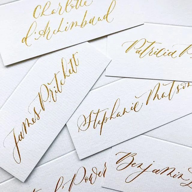 Gold modern script names on laid white