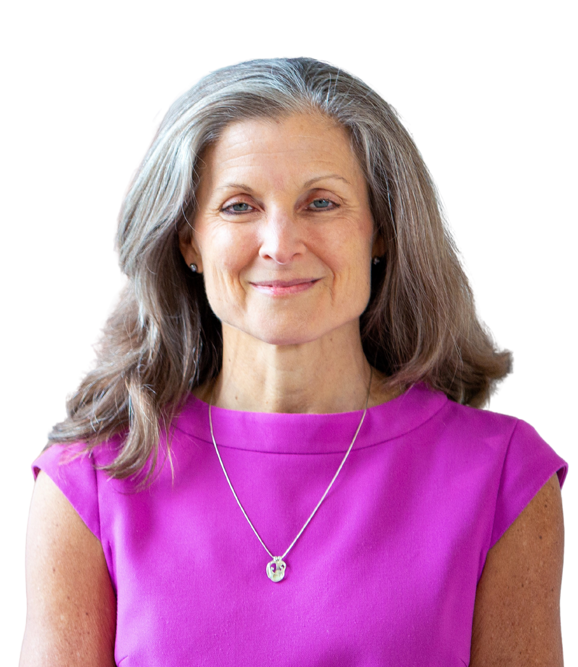 Close-up of a woman with long, gray hair wearing a purple top and a necklace with a pendant, smiling softly.