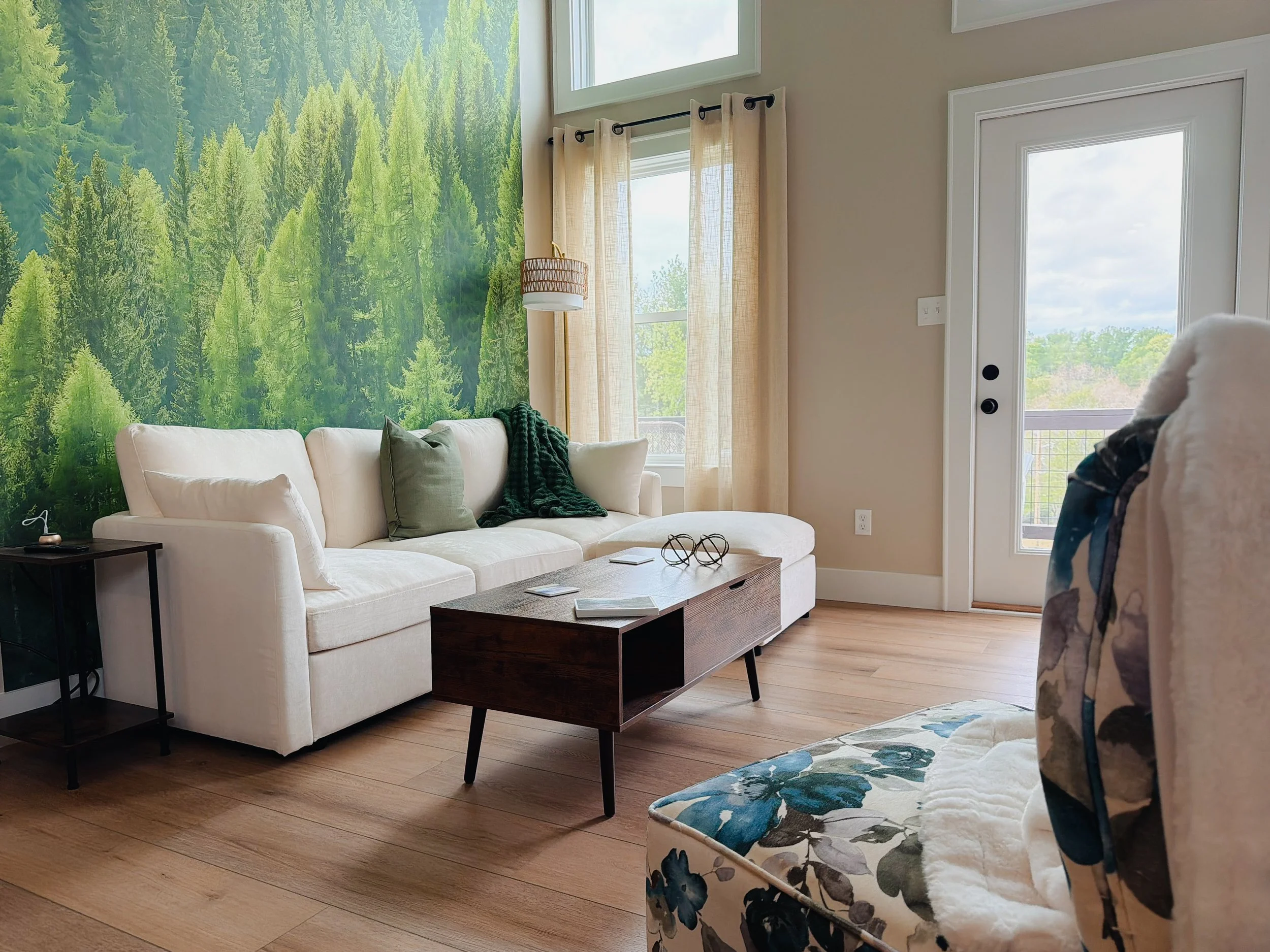 Cozy living area with forest mural