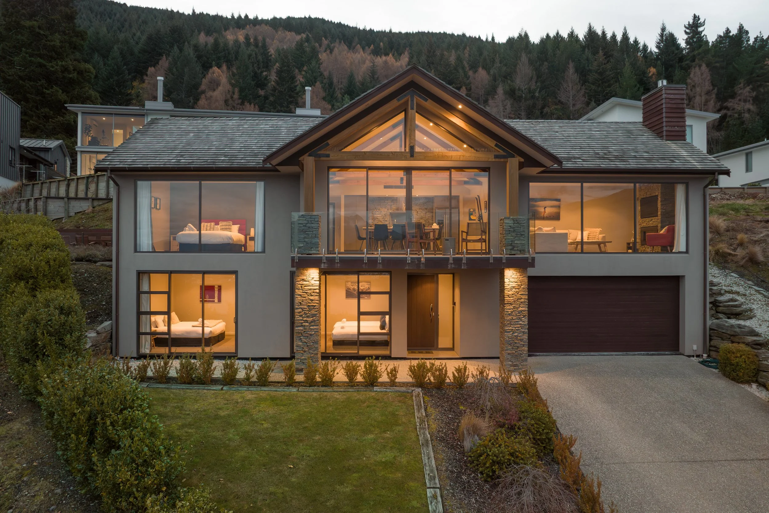 A dusk evening shot of the front of Panorama Paradise a Queenstown holiday home managed by Be Our Guest