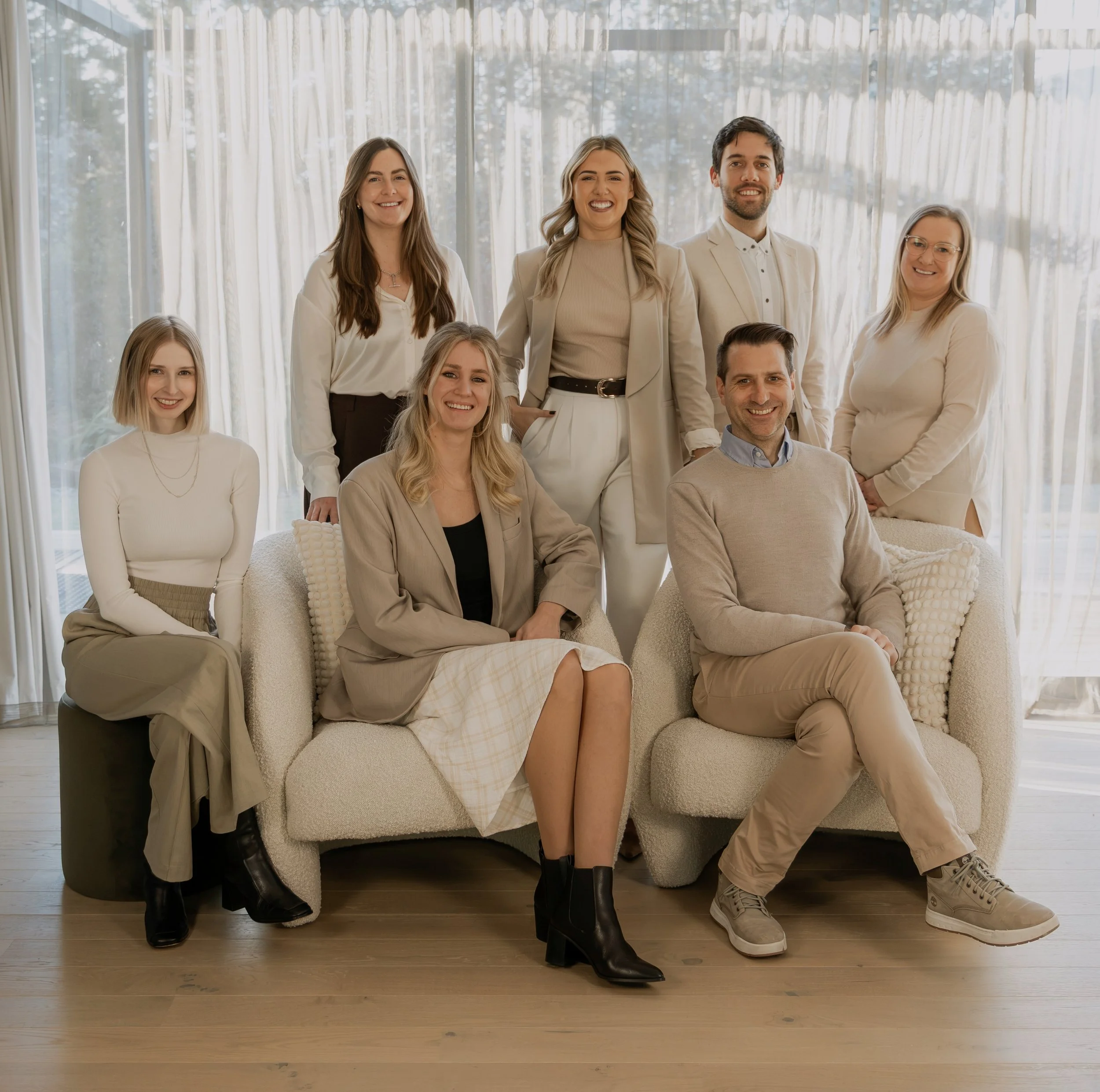 The Be Our Guest by Bayleys Queenstown and Wanaka team posed together for a group portrait.