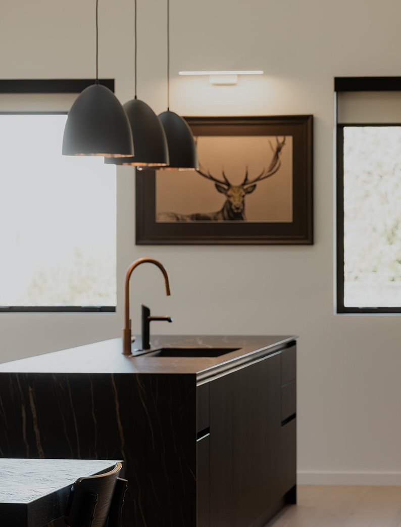 Looking over towards a framed deer artwork in the kitchen of a home managed by Be Our Guest.