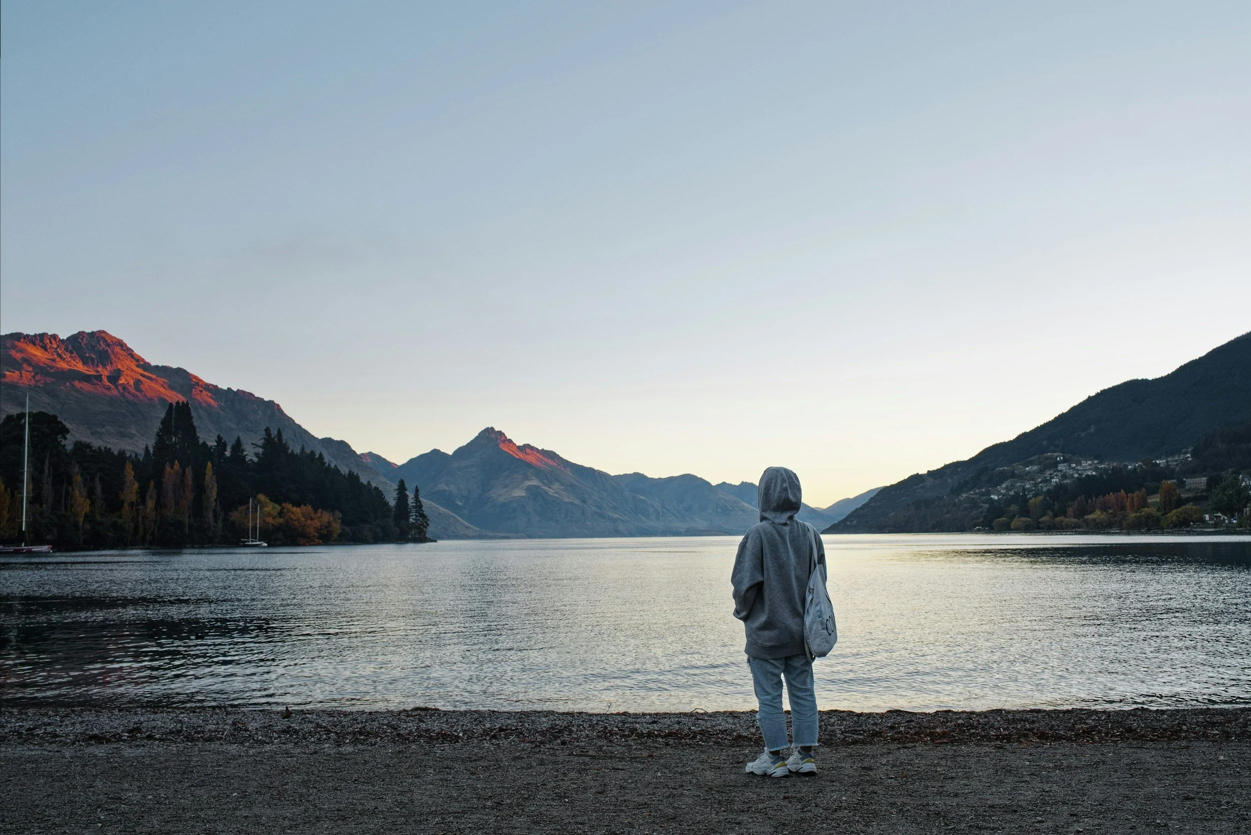 An individual looking out towards the lake in Queenstown.