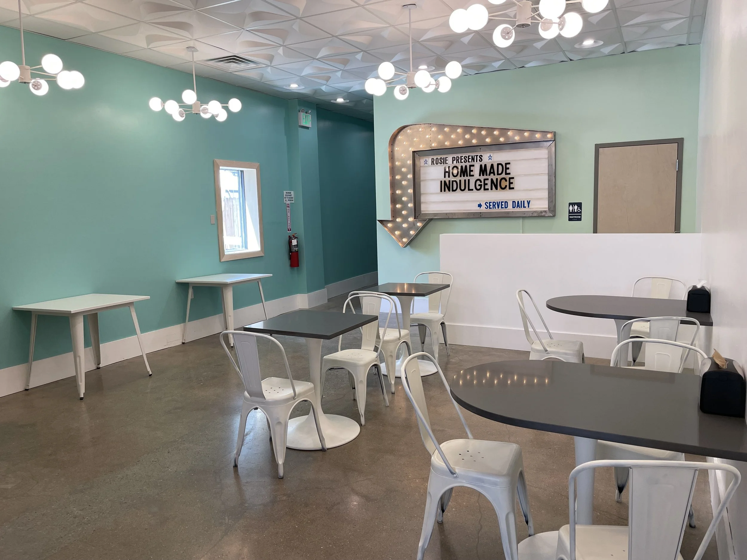 An image of lighting, ceiling, seating and color design.