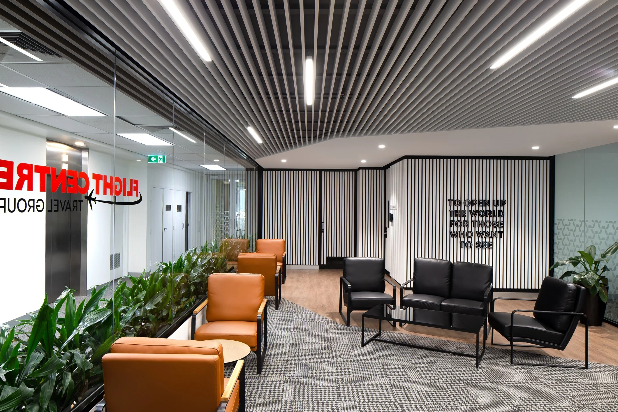 Interior of an airport lounge with seating, plants, and modern ceiling design.