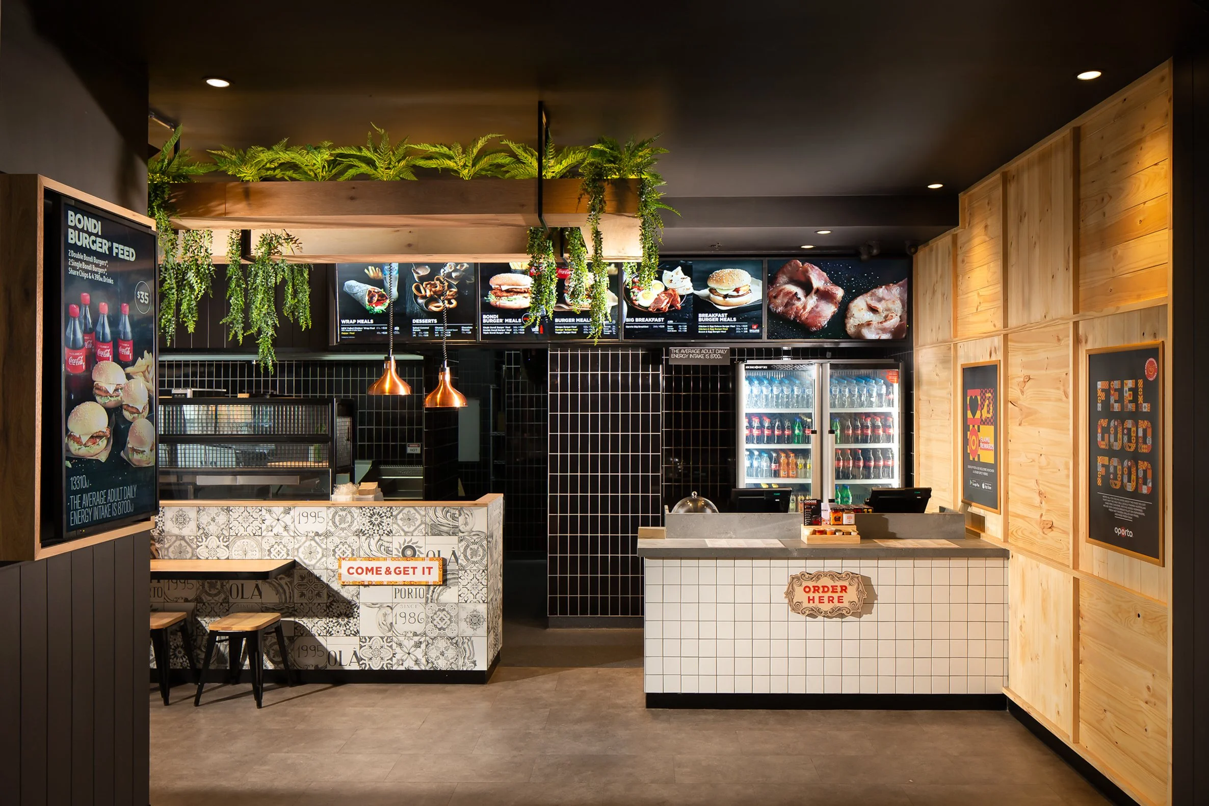Fast food restaurant order counter with menu boards, beverage refrigerator, and seating area.