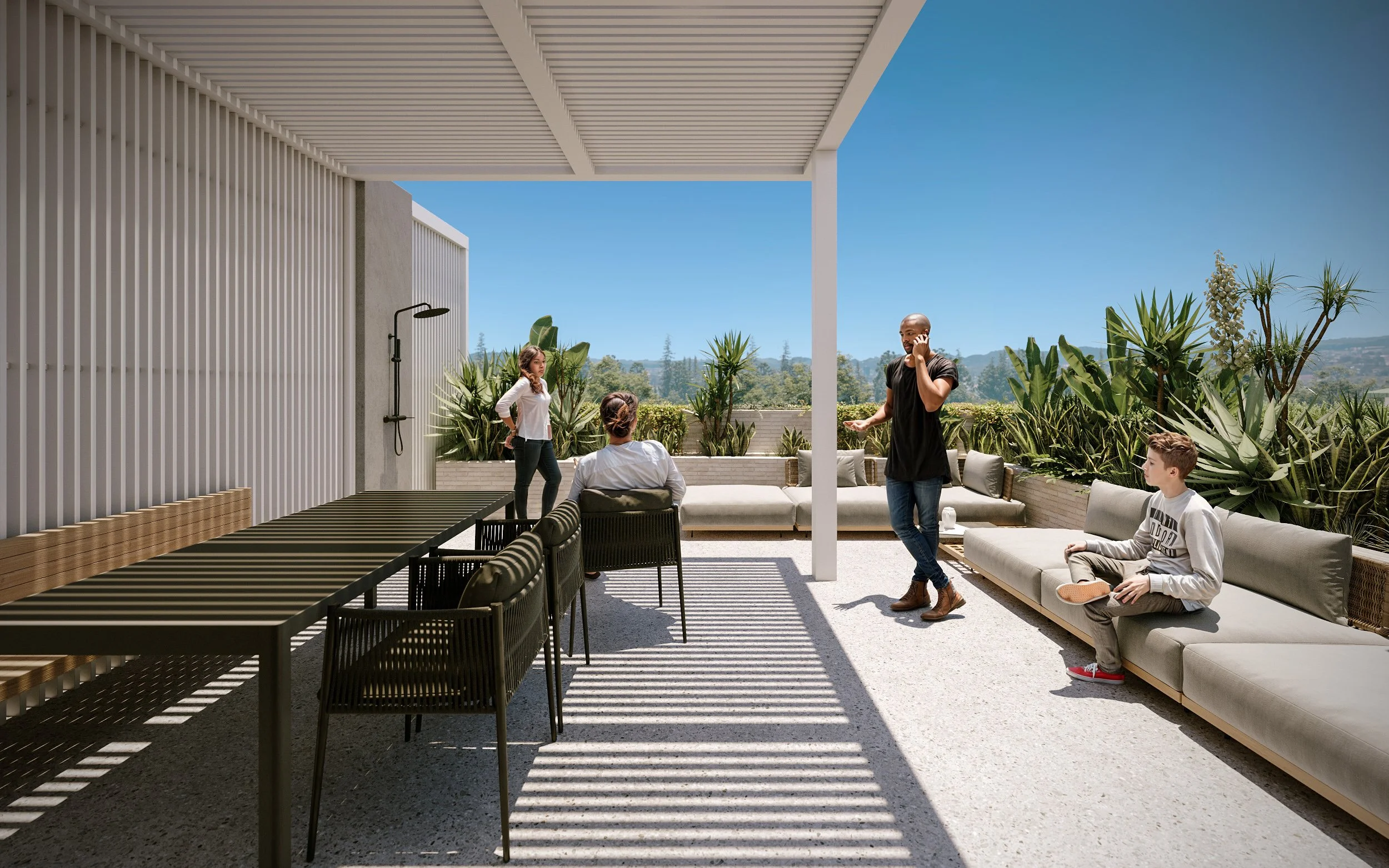 Outdoor patio with modern furniture and five people socializing under a shaded pergola, with lush greenery and distant hills in the background.