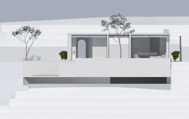 Modern house exterior with a balcony, trees, and minimal landscaping.