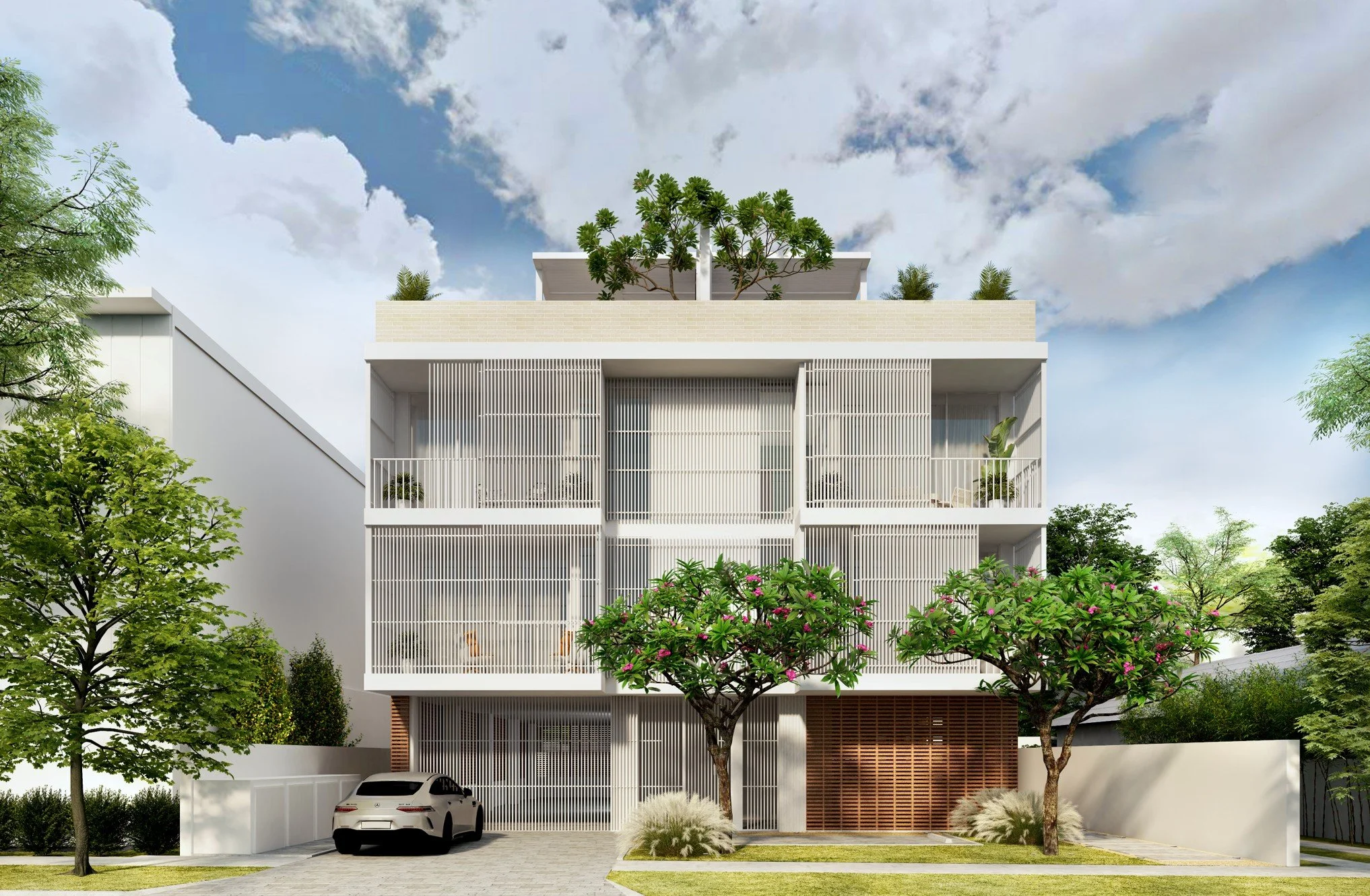 A modern multi-story building with white vertical slats, surrounded by trees and greenery. A car is parked in front, and the building features rooftop trees and outdoor spaces under a partly cloudy sky.