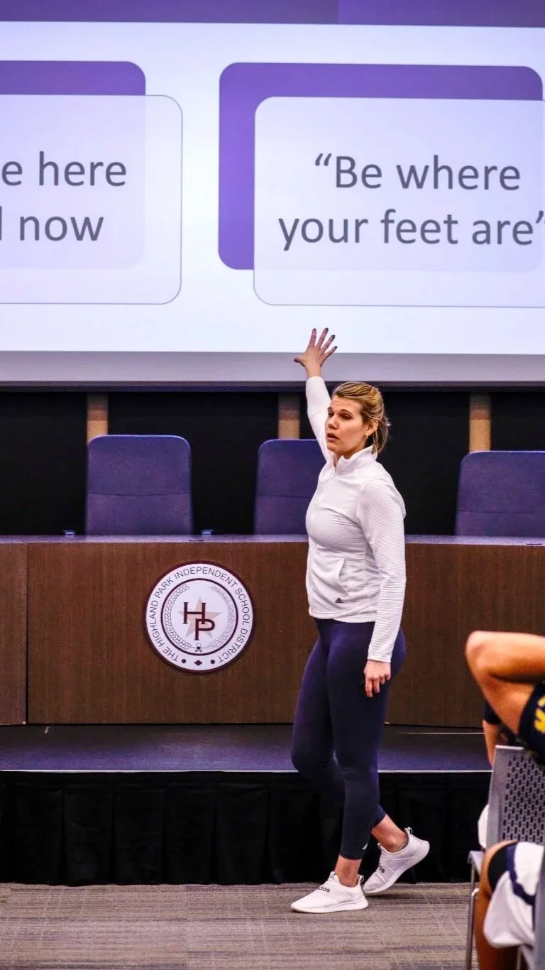 Emily Perrin delivering a keynote on athlete mental health and performance