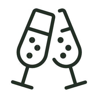 Two champagne flutes clinking together with bubbly inside
