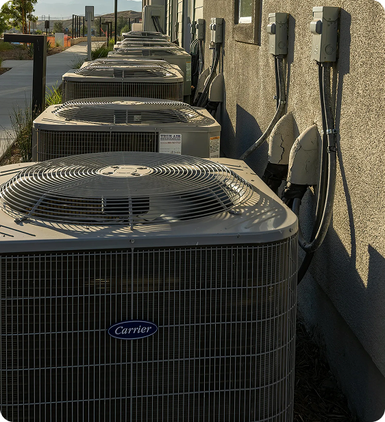 Multiple air conditioning units installed outside a building.