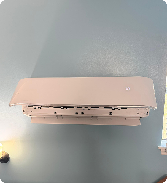 Wall-mounted white air conditioner unit displaying the temperature 70°F.