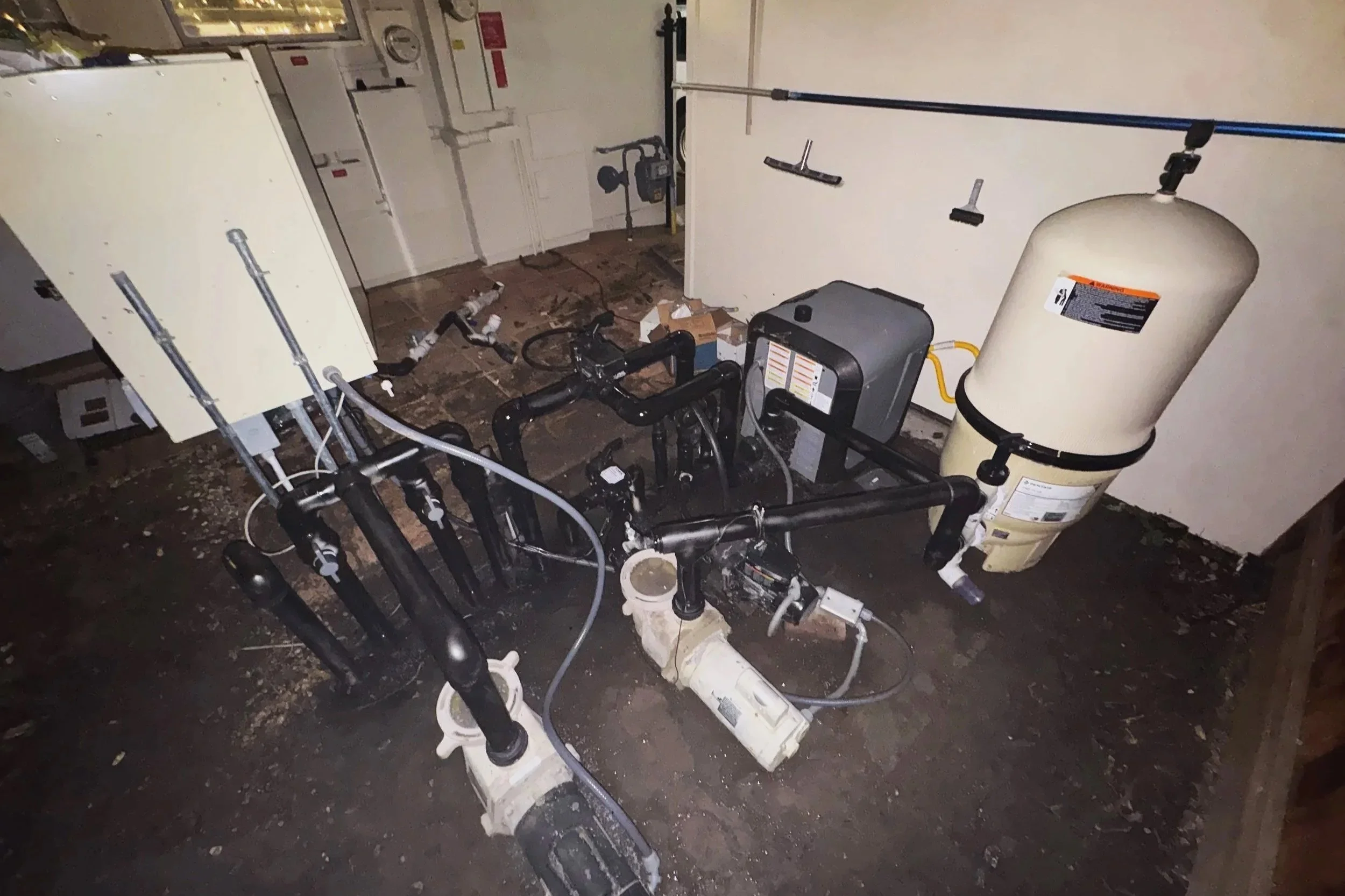 Image of a water filtration or pump system with various pipes and filters.