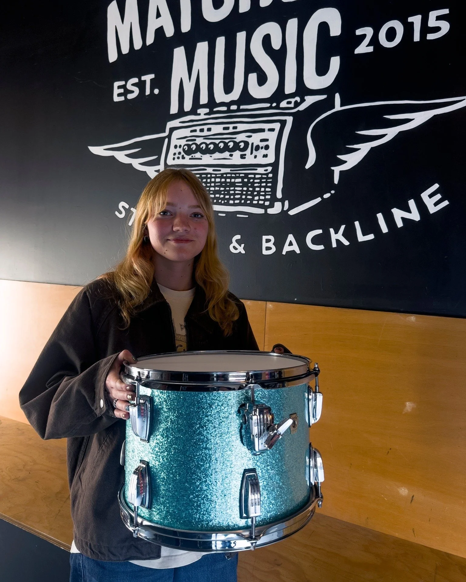 Last day for our work experience kid Rebeka! Here she is with a @ludwigdrumshq Classic Maple 13x9 tom she helped re wrap in Delmar Turquoise Sparkle to match one of our existing backline kits. Once re assembled she fitted new @evansdrumheads and lear