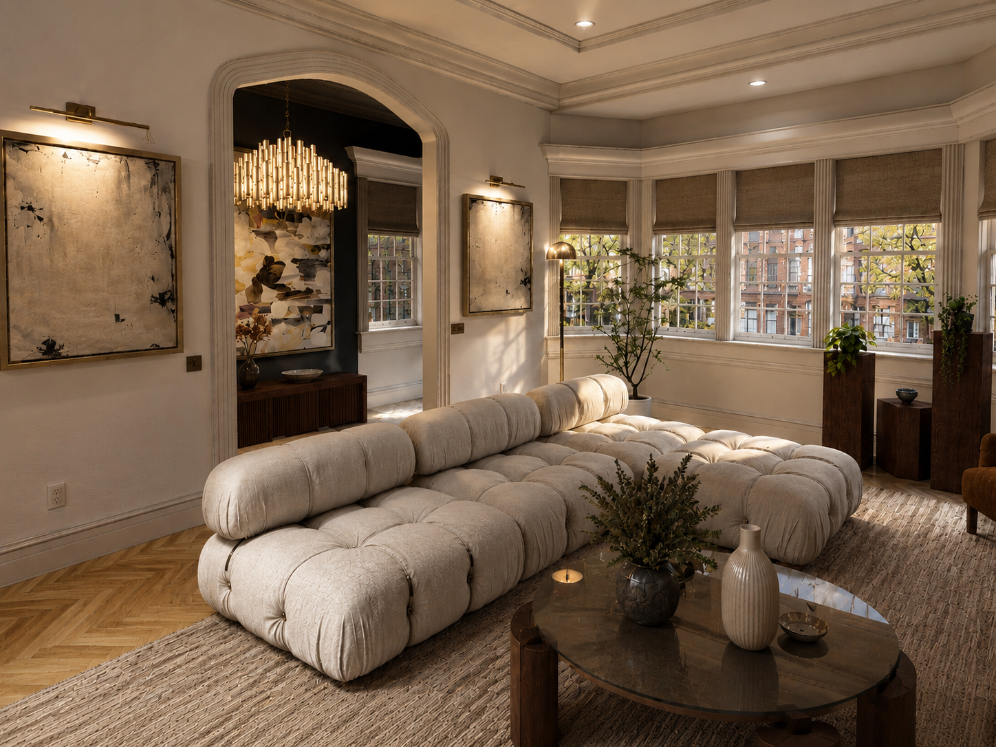 Living Room - Introduced archways and a stepped ceiling bring architectural rhythm to the living room, while the original fireplace anchors the space in the brownstone’s historic character. A cream Bellini sofa, warm wood tones, and sculptural lighti