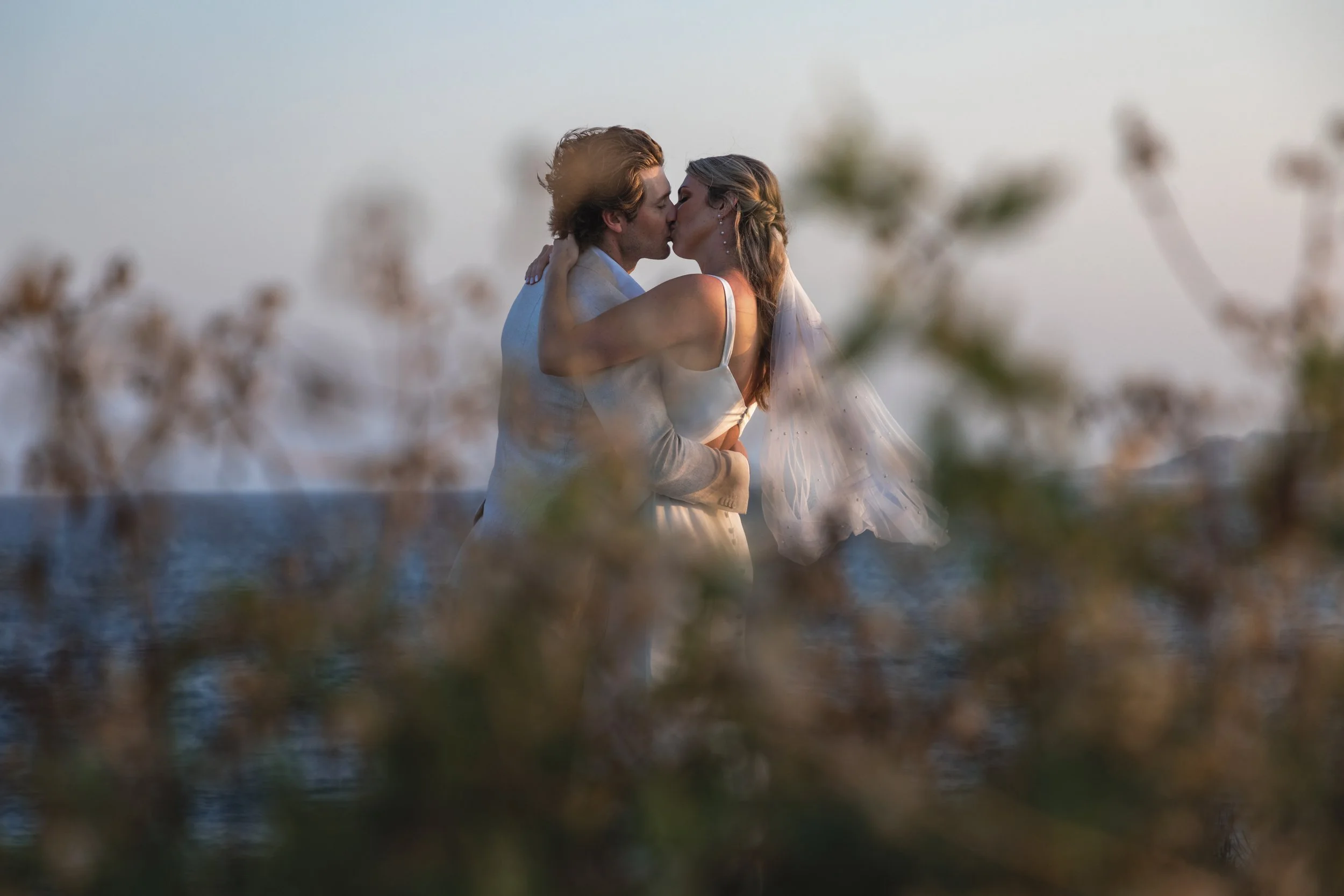 Destination wedding couple in Los Cabos with romantic beach setting and event styling by I DO Weddings Los Cabos.
