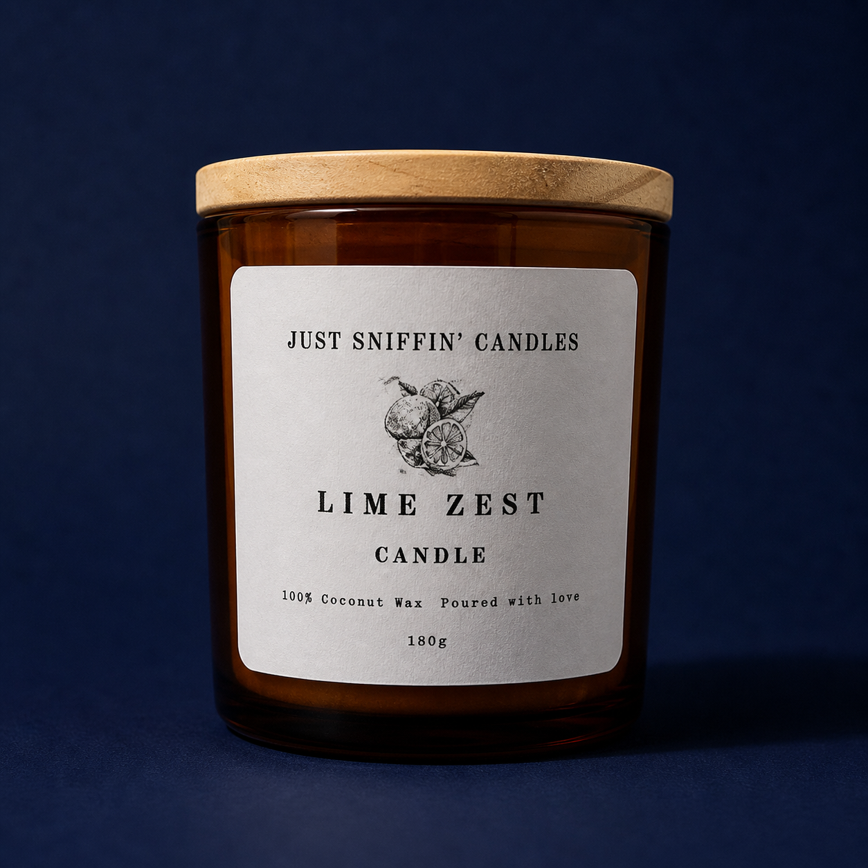 Amber glass candle jar with a wooden lid labeled 'Just Sniffin' Candles Lime Zest Candle,' featuring a lemon and lime illustration, and text indicating it is made from 100% coconut wax, poured with love, weighing 180 grams.