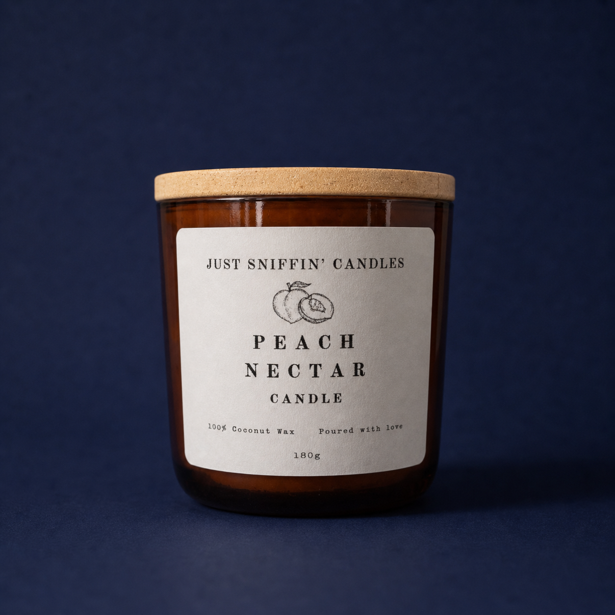 A brown candle jar with a wooden lid, labeled 'Just Sniffin' Candles Peach Nectar Candle', with a simple illustration of a peach, on a dark blue background.