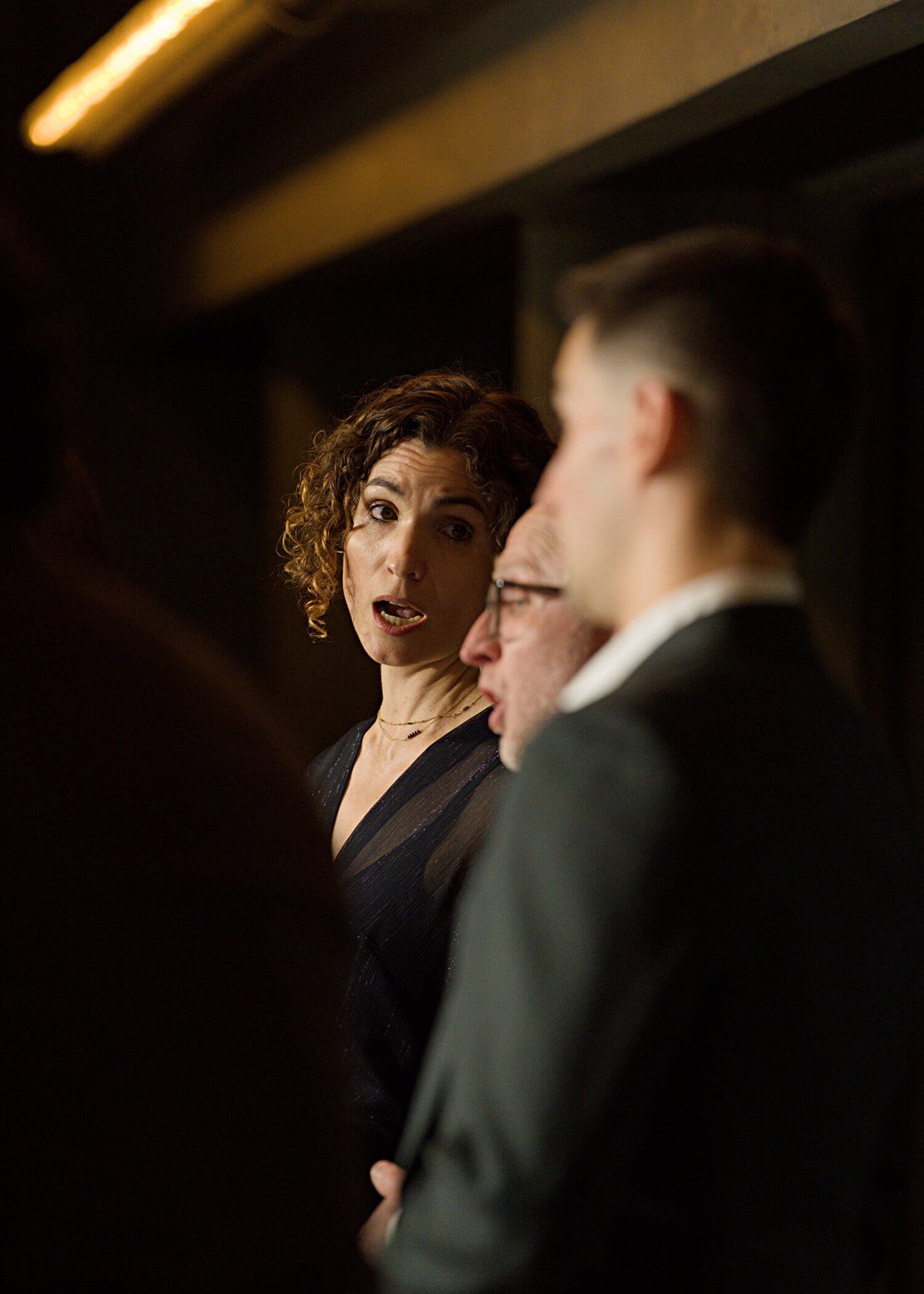 Jessica O'Donoghue engaging in conversation with a man in a suit at a formal event.