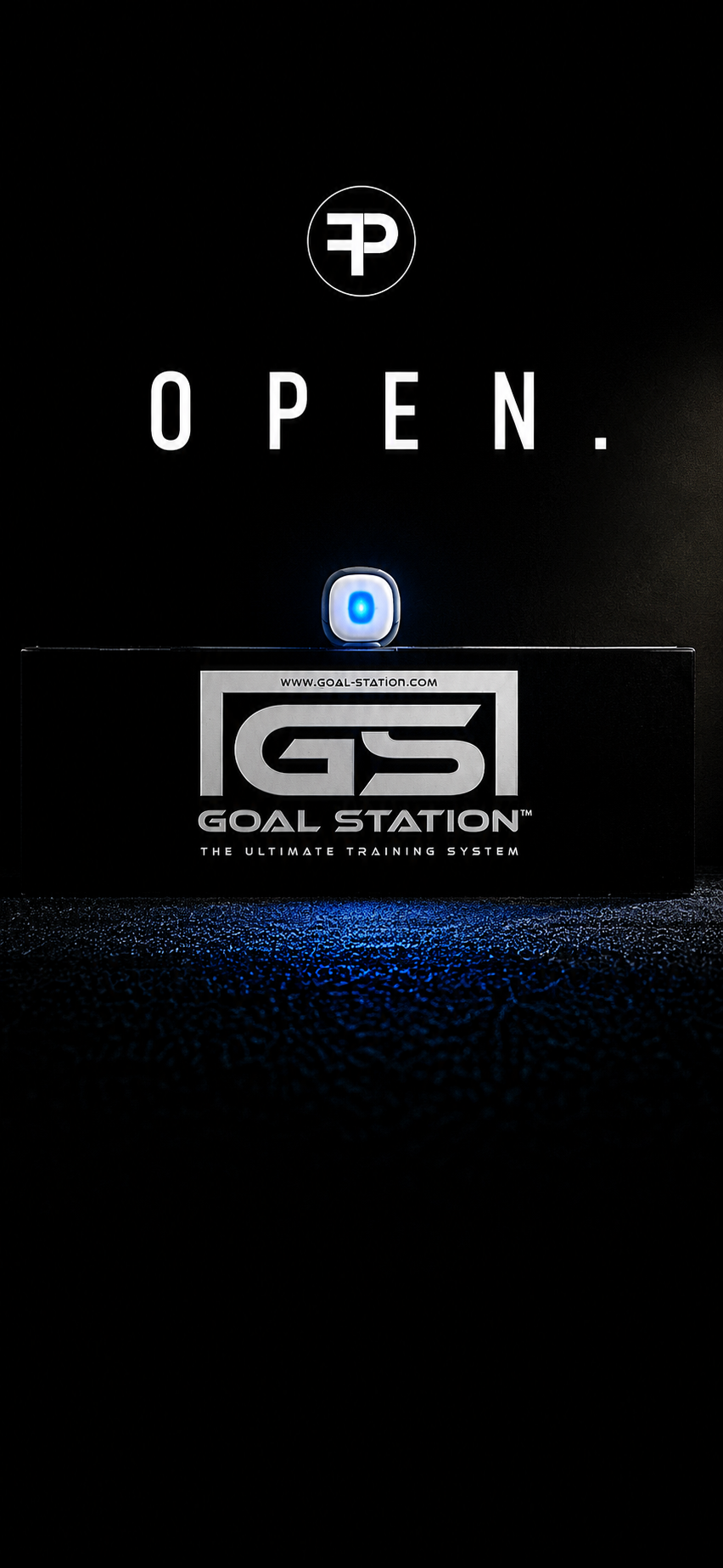 A black display screen with the word 'OPEN.' in white letters, a small blue and white device, and a black box labeled 'Goal Station' with the website 'www.goal-station.com' on it, indicating the opening of a training system.