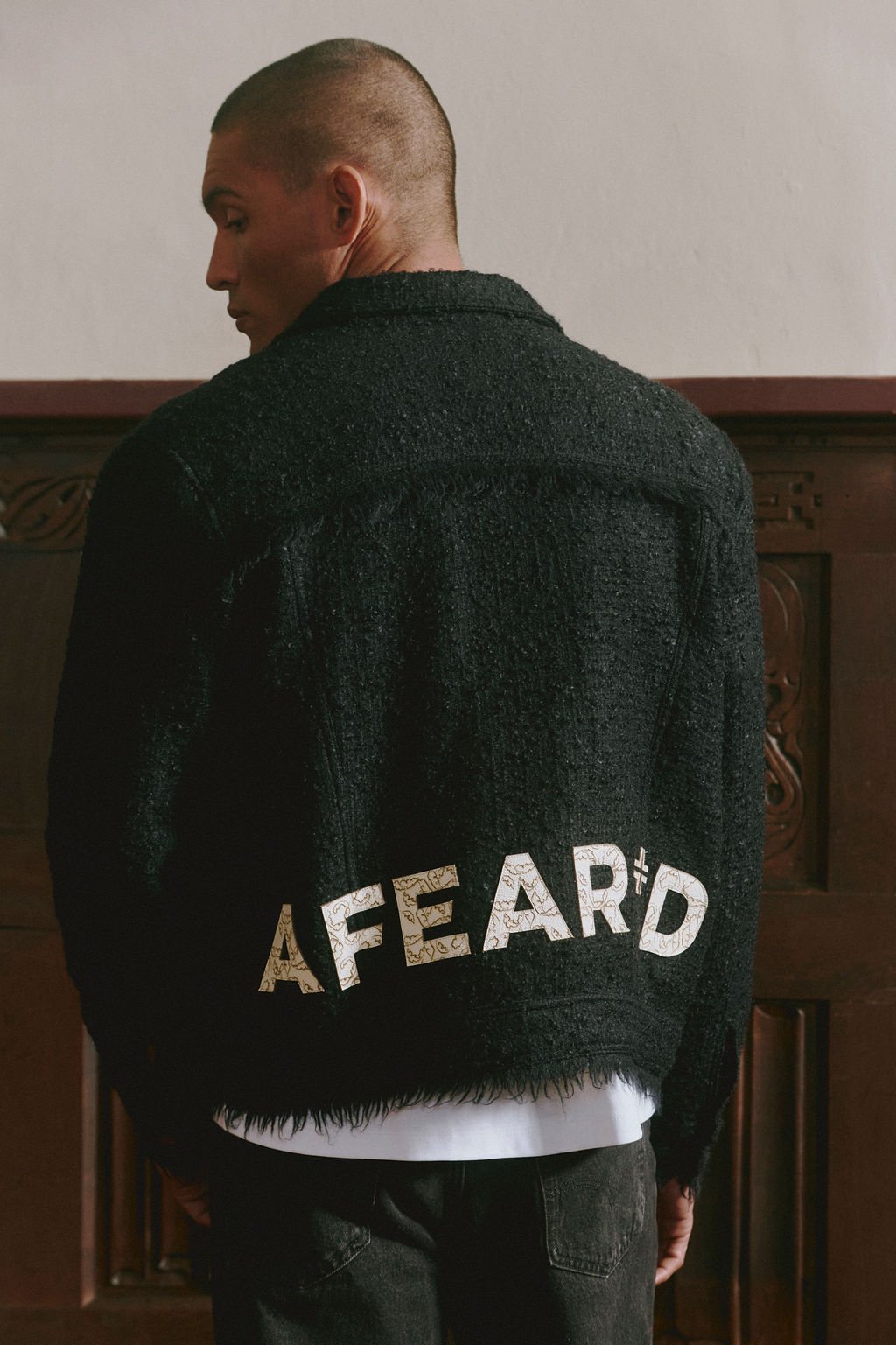 The AFEAR+D wordmark across the back of a hoodie.