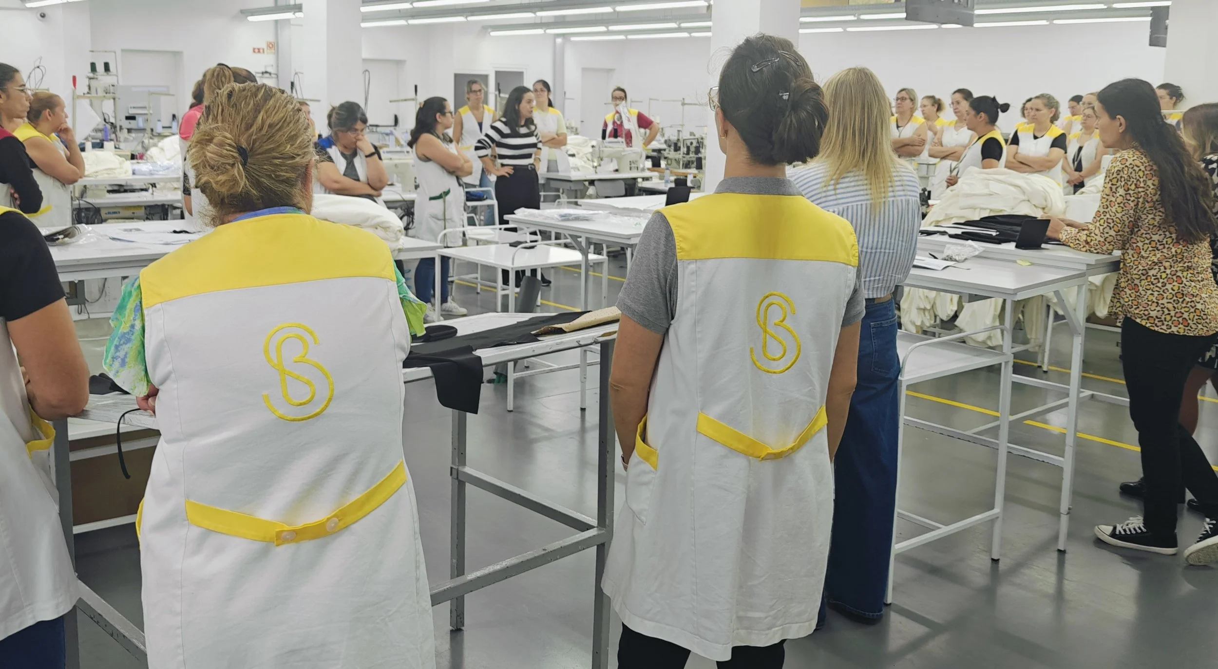 Workers on a clothing factory production floor — understanding production minimums and MOQs
