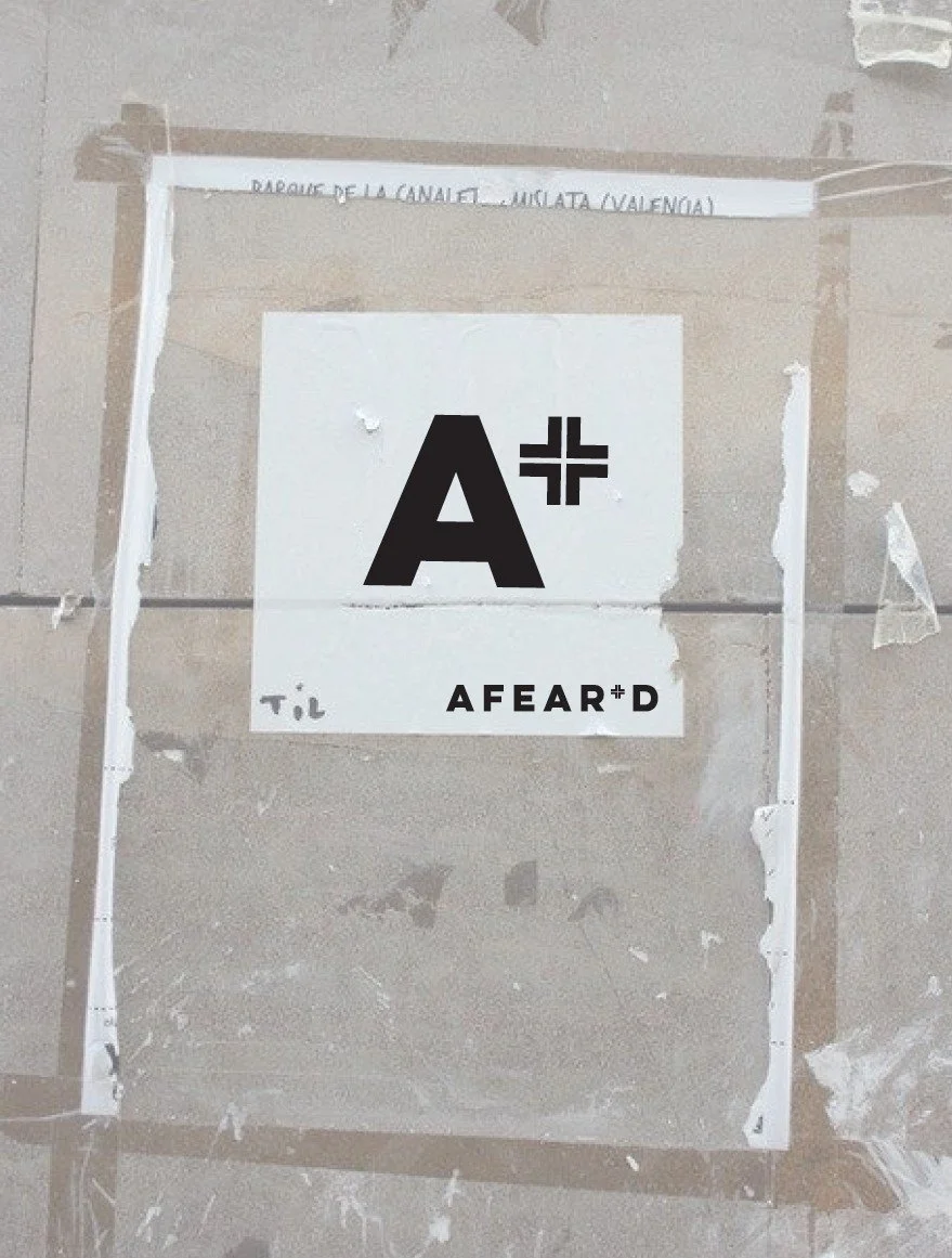 The AFEAR+D 'A+' shorthand mark and wordmark on a textured wall.