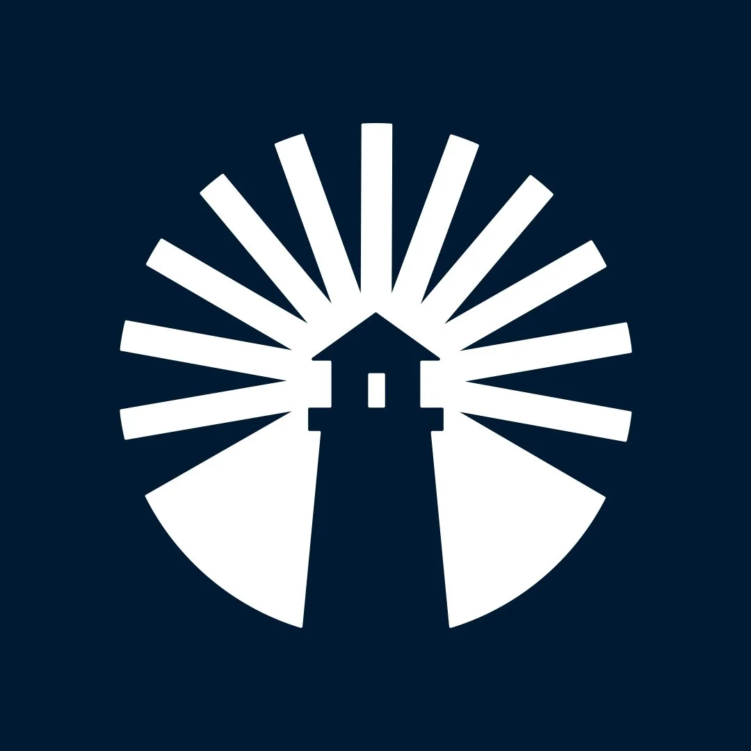 A lighthouse with a circular burst of rays behind it, depicted in a simple white silhouette on a dark blue background.