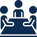 Two people sitting at a table, engaging in a conversation or meeting.