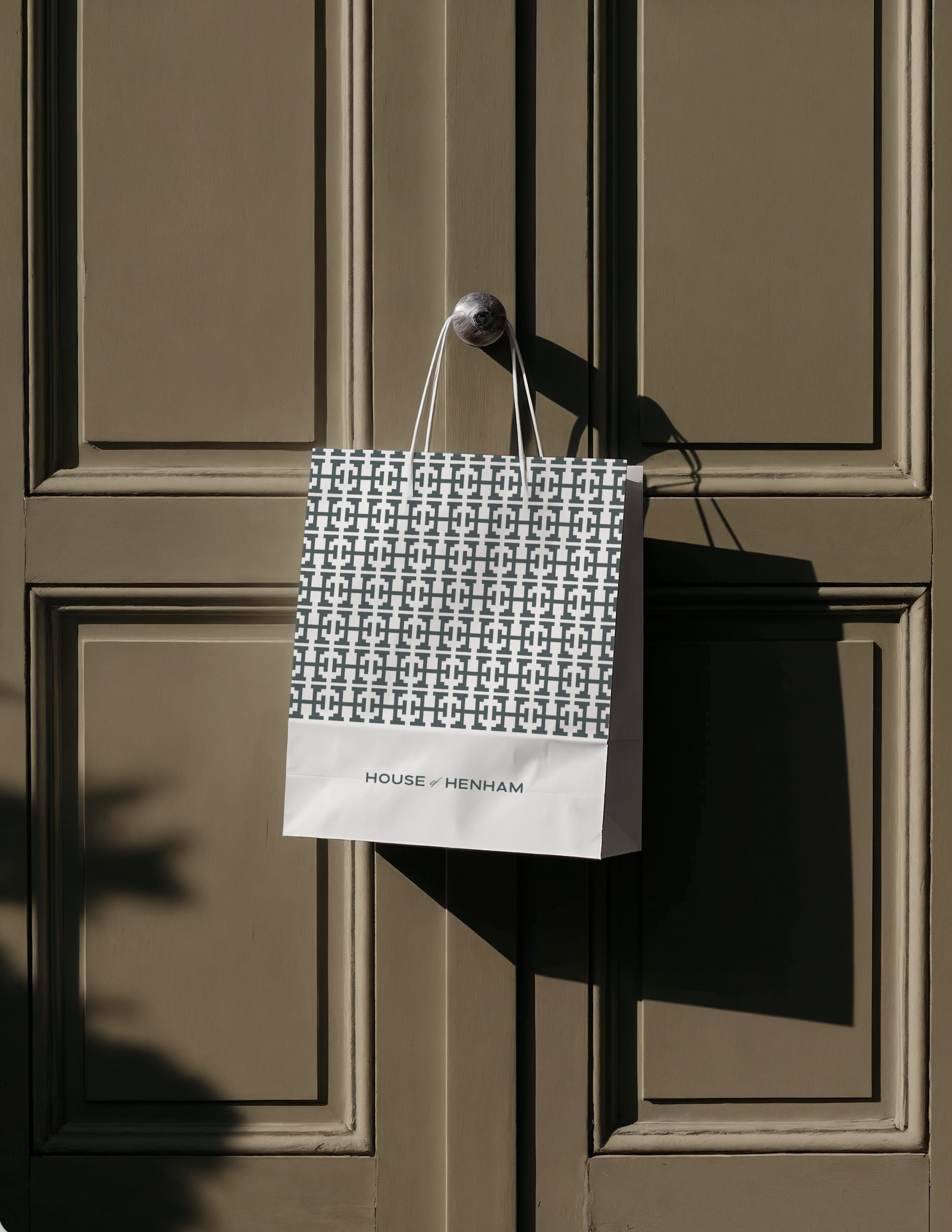 A House of Henham wine bag hanging on a door knob.