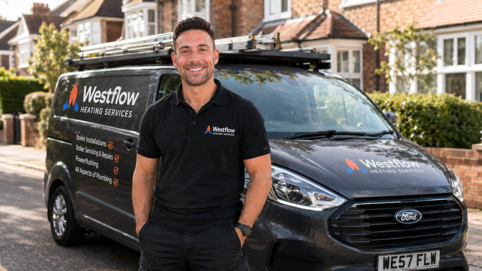A smiling man in a black Westflow Heating Services polo standing in front of a black company van with the same logo, parked on a residential street.